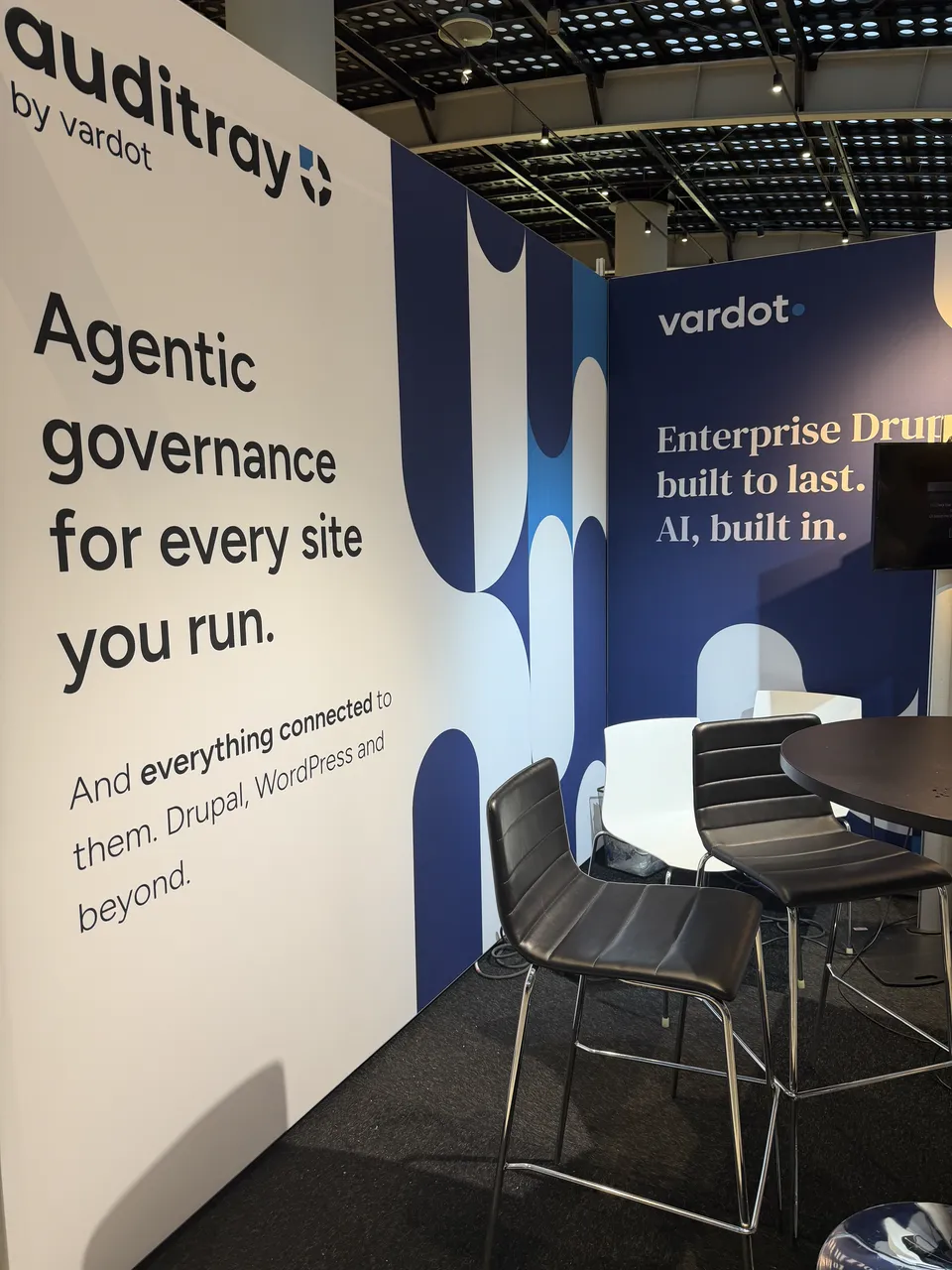 The Auditray booth wall: “Agentic governance for every site you run.”